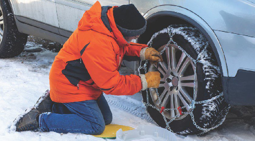 Putting snow chains on tire